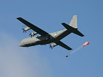 A C-130J making a parachute drop