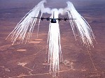 A C-130J dropping flares