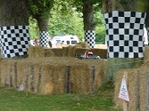 The racetrack at Goodwood is very narrow, and surrounded by safety barriers. This makes for exciting driving as with this early Formula One car