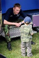 A fascinated young fan gets the backgound to the Team and Army flying.