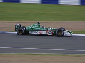 Meanwhile, out on the track, the Formula One cars were screaming round practicing. Here, Eddie Irvine's company car takes Becketts at speed