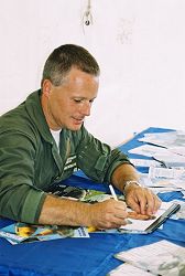 John Romain signs a calendar.