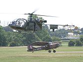 ....arriving                          as the fixed wing section lands on the runway making                          for some interesting pictures. Here the Alouette and                          Auster "cross"....